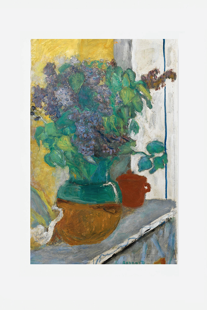 Purple lilac in a yellow and green earthen vase